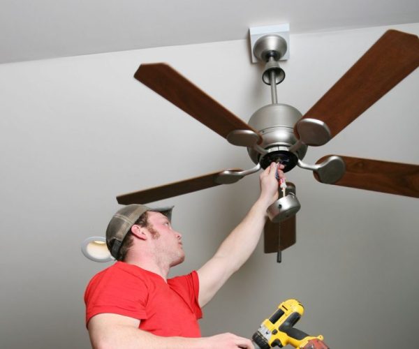 Electrician installing energy saving ceiling fan on home addition job in a sloped ceiling 1024x683 1