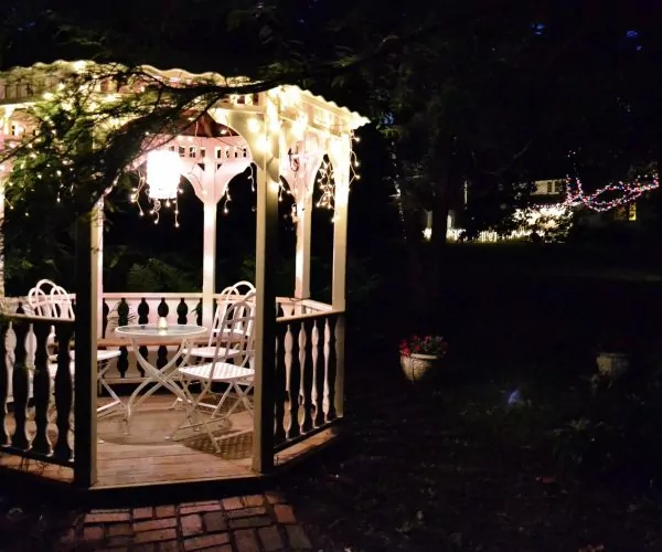 gazebo in a garden at night with lights a table a 2022 11 15 14 03 44 utc scaled